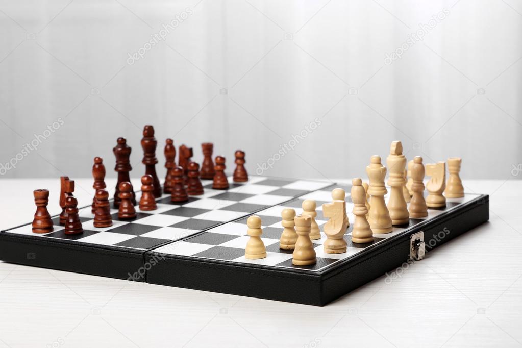 Chess pieces and game board Stock Photo by ©belchonock 100249786