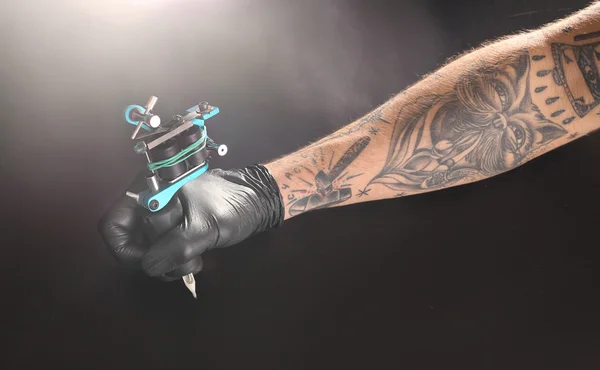 Tattooist hand in medical glove — Stock Photo, Image