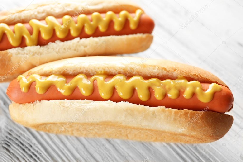 Two hot dogs on wooden background