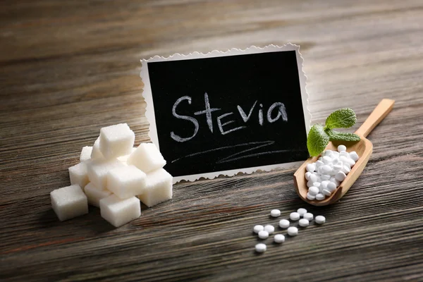 Слово STEVIA написано на черной доске и сахаре — стоковое фото