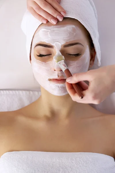 Young woman with facial mask Stock Photo