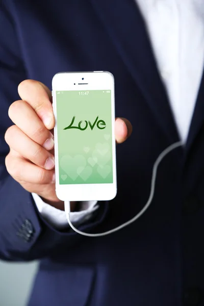 Smartphone with romantic screensaver — Stock Photo, Image