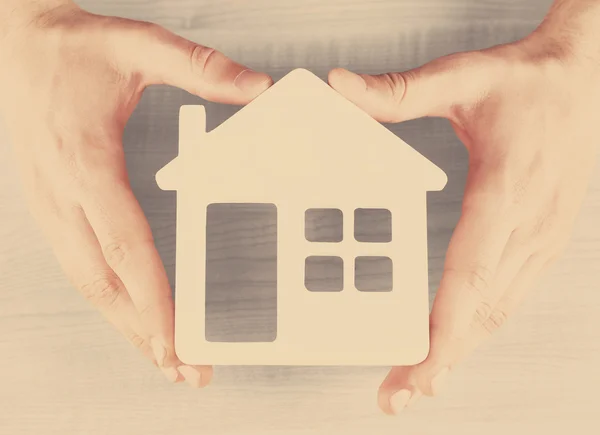 Hands holding model of house — Stock Photo, Image