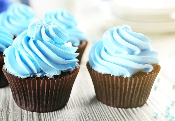 Blue cupcakes on wooden table — Stock Photo, Image