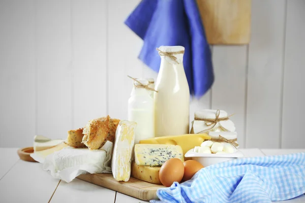 Set of fresh dairy products on white wooden table — Stock Photo, Image