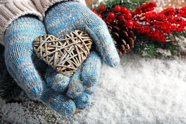 Hands in mittens with decorative heart — Stock Photo, Image