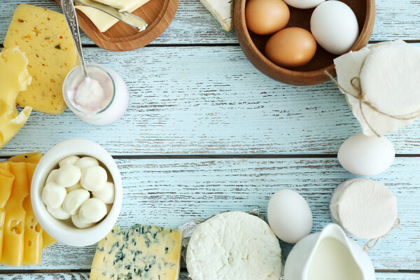 Frame of fresh dairy products on blue wooden table