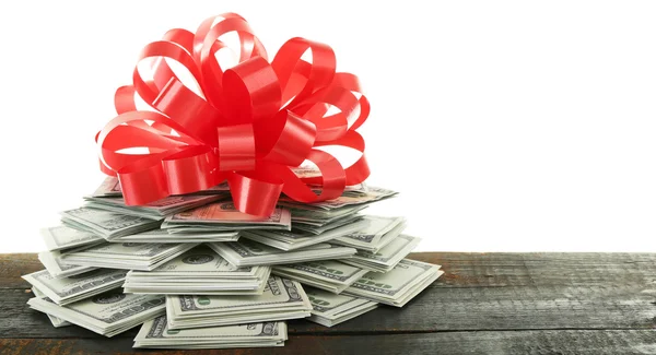 Pile of dollars with bow as gift — Stock Photo, Image
