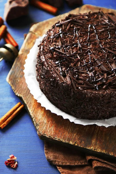 Tasty chocolate cake on color wooden background — Stock Photo, Image