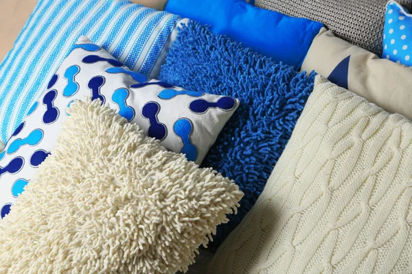 Decorative pillows on grey carpet — Stock Photo, Image