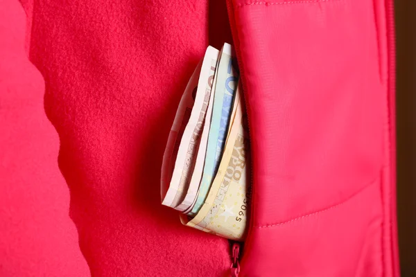 Cash in the red jacket pocket — Stock Photo, Image