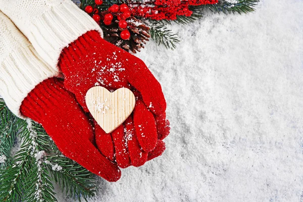 Hands in mittens with decorative heart — Stock Photo, Image
