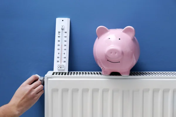 Hand adjusting the temperature on radiator. — Stock Photo, Image