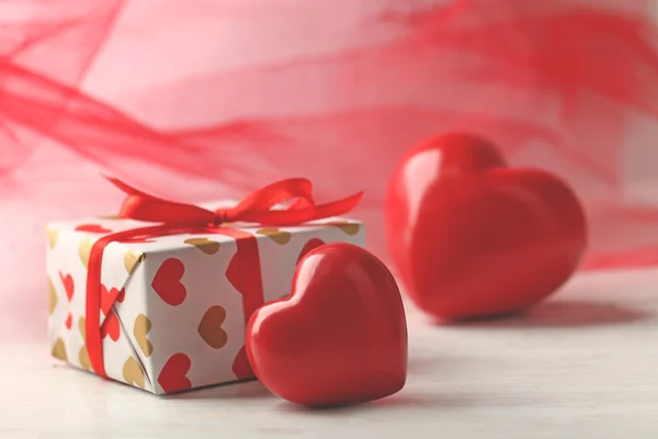 Gift box and decorative hearts — Stock Photo, Image