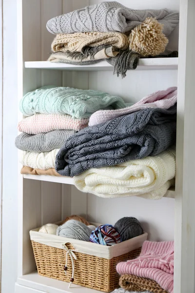 Knitting clothes on shelf — Stock Photo, Image