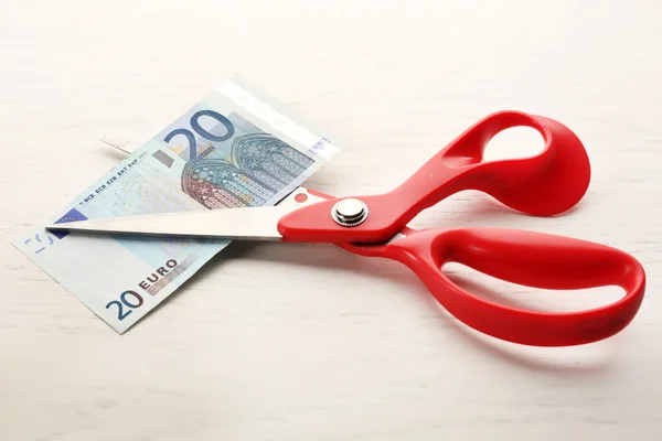 Scissors cuts euro banknote on table — Stock Photo, Image