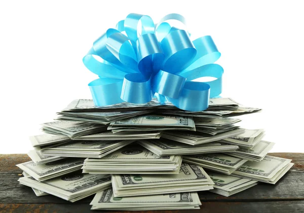 Pile of dollars with bow as gift — Stock Photo, Image