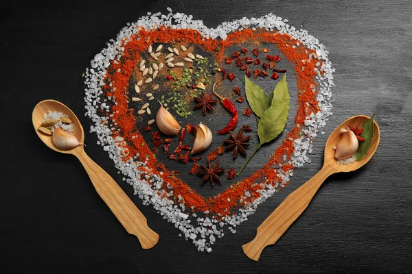 Spices on table in shape of heart on wooden table — Stock Photo, Image