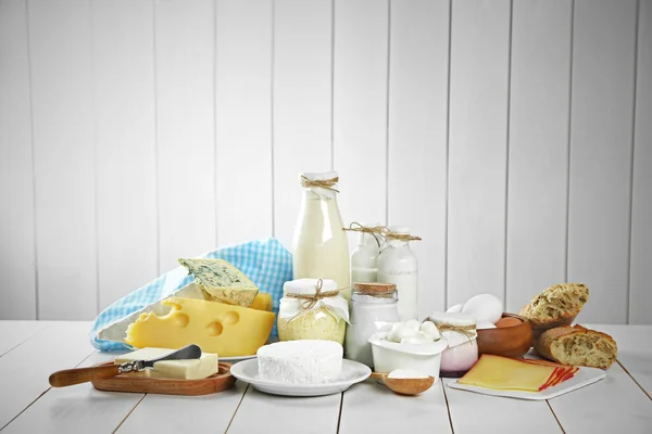 Set of fresh dairy products on white wooden table — Stock Photo, Image