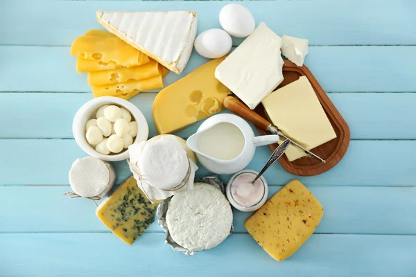 Set of fresh dairy products on blue wooden table, close up — Stock Photo, Image