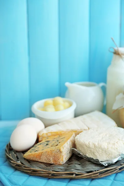 Set of fresh dairy products on blue wooden table, close up — Stock Photo, Image