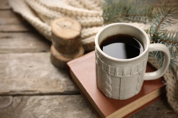 Tazza di bevanda calda con sciarpa invernale calda lavorata a maglia su vecchio tavolo di legno — Foto Stock