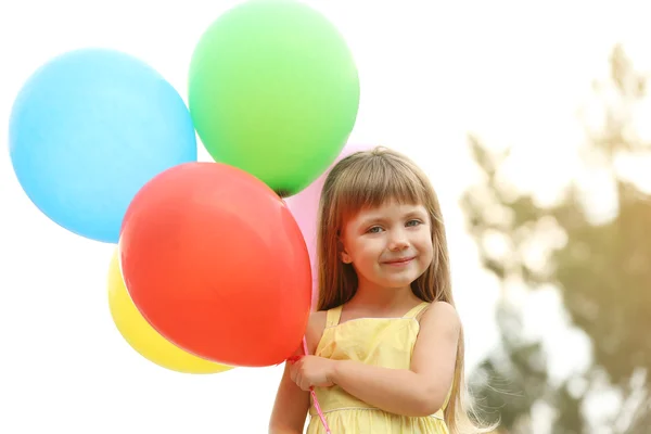 Liten flicka med ballonger — Stockfoto