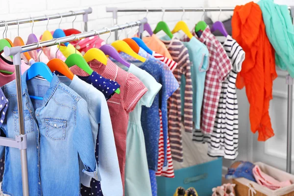 Clothes for kids on hangers — Stock Photo, Image