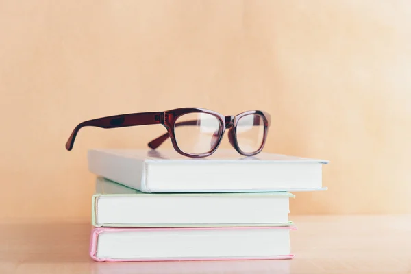 Pile of books and eyeglasses — Stock Photo, Image