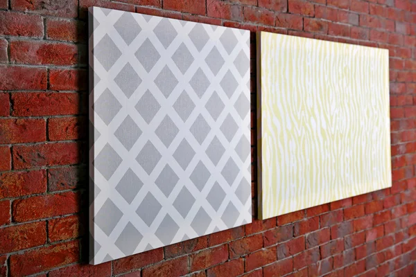 Abstract pictures on brick wall