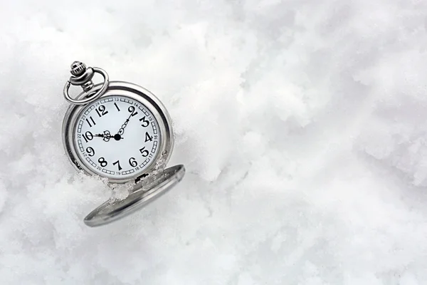 Pocket watch over white snow — Stock Photo, Image