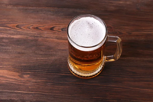 Glass of beer on wooden background — Stock Photo, Image