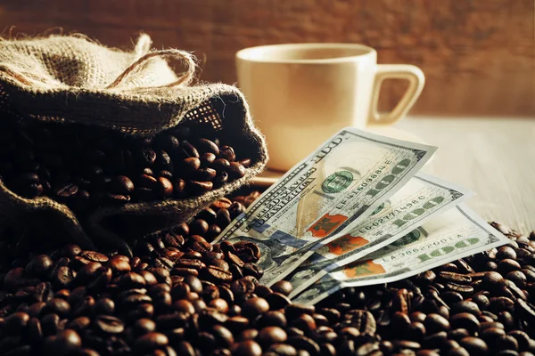 Coffee beans and dollar banknotes Stock Photo