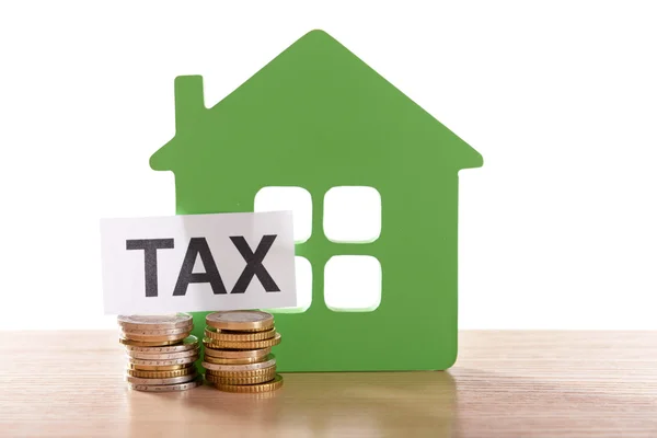 House figure, coins and tax sign — Stock Photo, Image