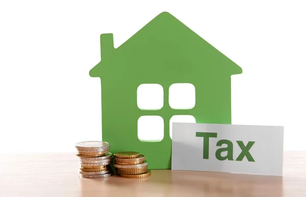 House figure, coins and tax sign — Stock Photo, Image