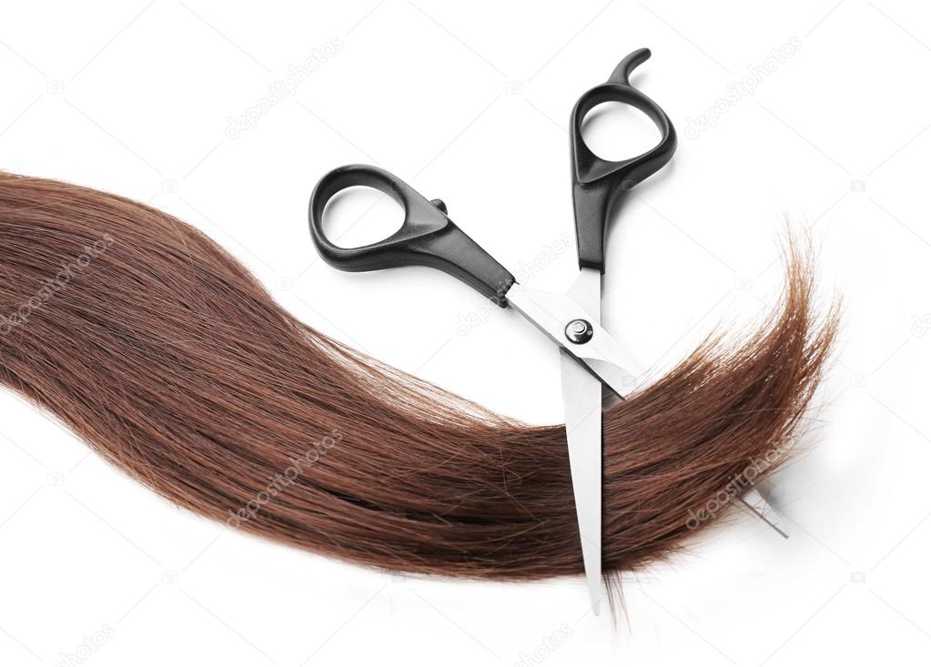 scissors with strand of dark brown hair 