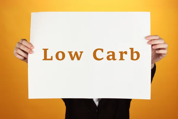 Woman holding paper with Low-Carb text — Stock Photo, Image