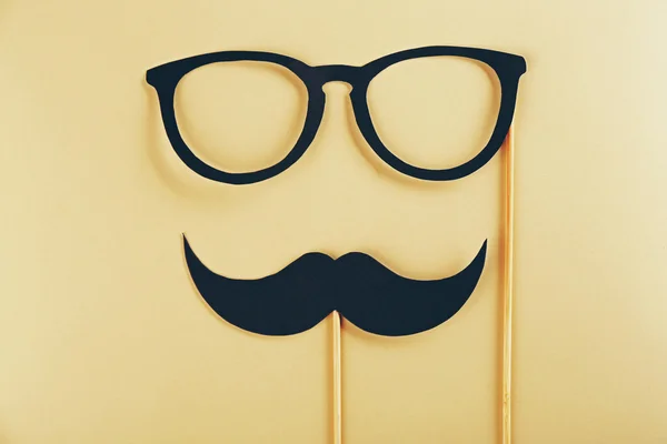 Photo booth props glasses, mustache on beige background — Stock Photo, Image