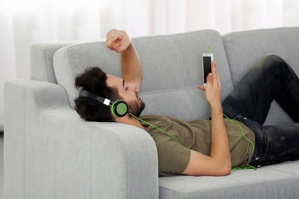 Young man listens music with headphones — Stock Photo, Image