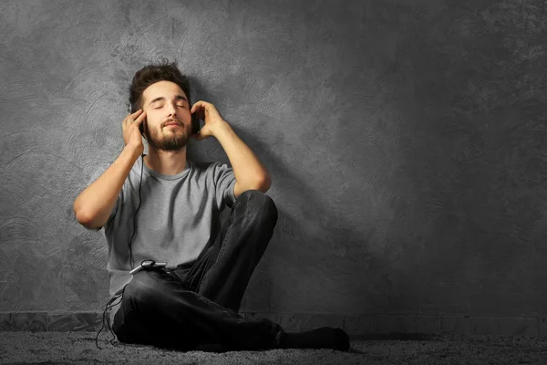 Молодий бородатий чоловік слухає музику — стокове фото