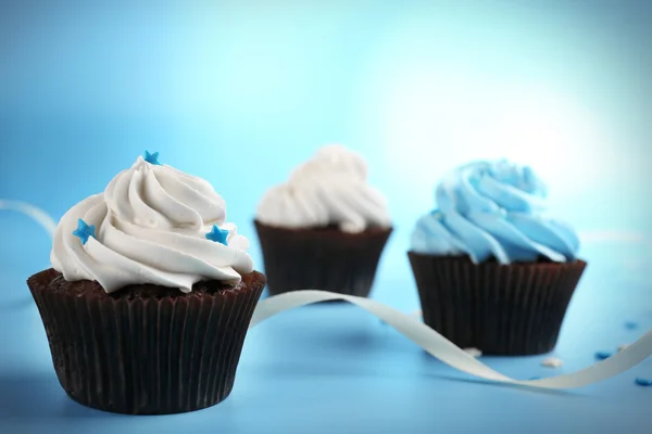 Chocolate cupcakes on blue background — Stock Photo, Image