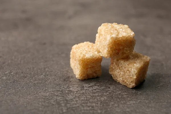 Pile of brown sugar cubes on the table — Stock Photo, Image