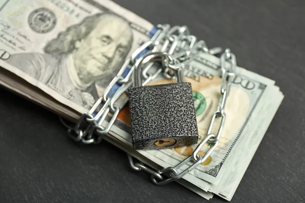 Dollars currency with lock and chain — Stock Photo, Image