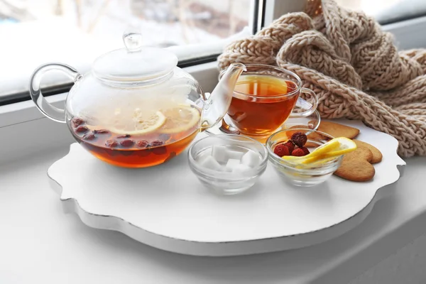 Tea set on a white wooden mat on the windowsill — Stock Photo, Image