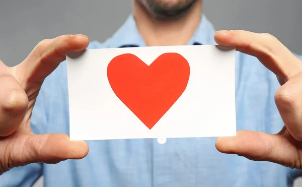 Young Man Holding Red Paper Heart Grey Background — Stock Photo, Image