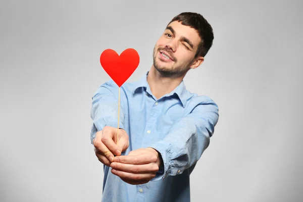 Hombre sosteniendo corazón de papel rojo —  Fotos de Stock