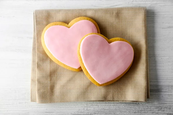 Galletas de corazón de San Valentín con servilleta en mesa de madera — Foto de Stock