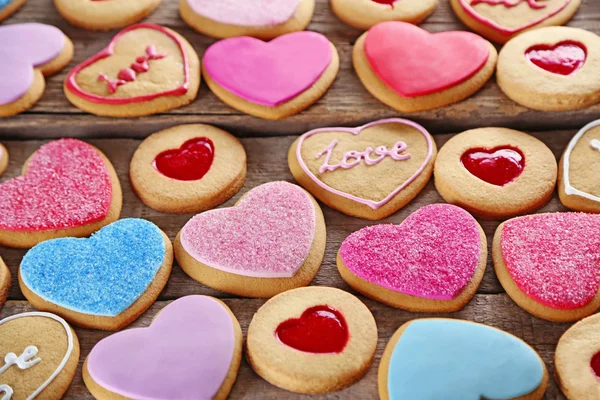 Assortment of love cookies on wooden background, closeup