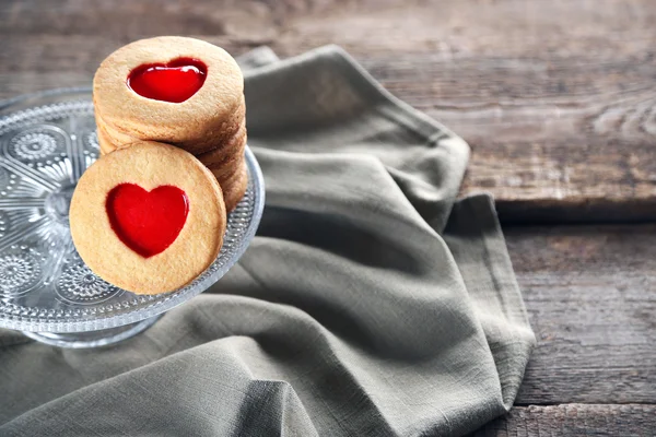 Love cookies with grey cloth on wooden background