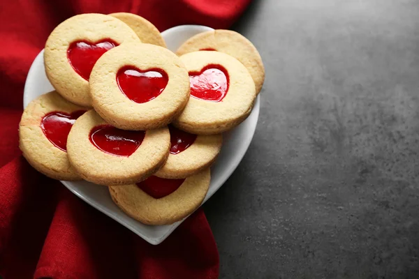 Assortiment de biscuits d'amour avec tissu rouge sur fond gris — Photo